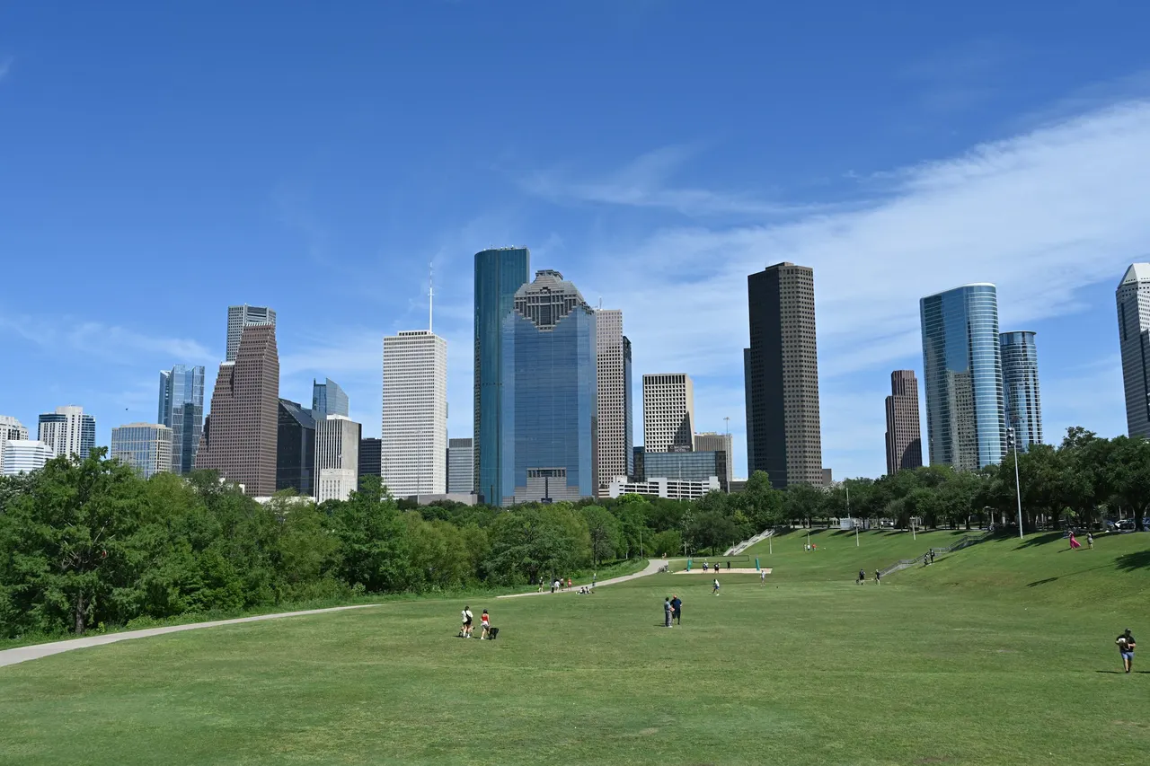 Downtown Houston skyline viewed across a green park